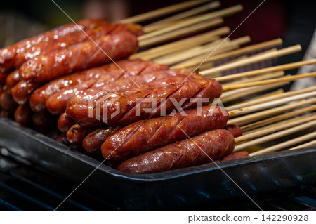 Taiwanese sausage skewers on a market charcoal grill Taiwanese sausage skewers on a market charcoal grill 142290928