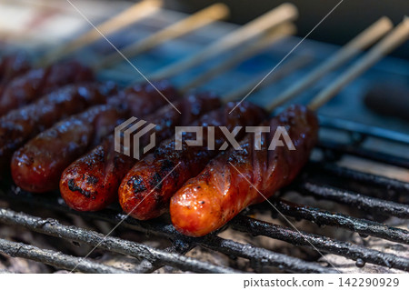 Taiwanese sausage skewers on a market charcoal grill Taiwanese sausage skewers on a market charcoal grill 142290929