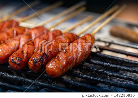 Taiwanese sausage skewers on a market charcoal grill Taiwanese sausage skewers on a market charcoal grill 142290930