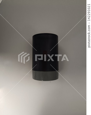 Black cylindrical smart speaker standing on a clean white surface, creating a minimalist technology composition for voice control, smart home, wireless audio and modern digital living Black cylindrical smart speaker standing on a clean white surface, creating a minimalist technology composition for voice control, smart home, wireless audio and modern digital living 142291021