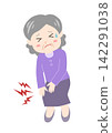 A senior woman clutches her knee with her hand, suffering from pain. 142291038