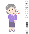 A senior woman suffering from stiff shoulders places her hand on her shoulder. 142291039