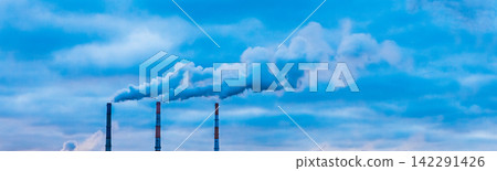 Environmental pollution, environmental problem, smoke from the chimney of an industrial plant or thermal power plant against a cloudy blue sky Environmental pollution, environmental problem, smoke from the chimney of an industrial plant or thermal power plant against a cloudy blue sky 142291426