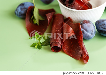Healthy plum pastila rolls with fresh fruit and copy space Healthy plum pastila rolls with fresh fruit and copy space 142291812