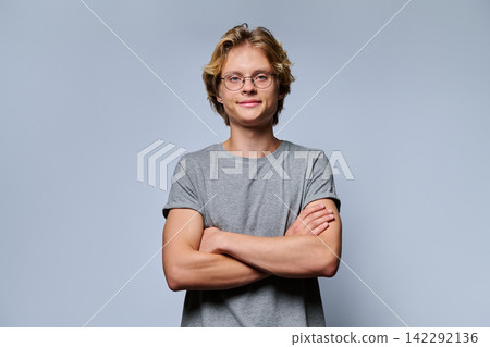 Portrait of confident teenage student in glasses with crossed arms Portrait of confident teenage student in glasses with crossed arms 142292136