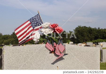 Close up of Military Veteran Headstone With American Flags Close up of Military Veteran Headstone With American Flags 142292239