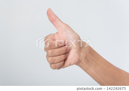 Human hand showing thumbs up gesture on white background, expressing approval, success, agreement and encouragement close up symbol of positive feedback, consent and motivation Human hand showing thumbs up gesture on white background, expressing approval, success, agreement and encouragement close up symbol of positive feedback, consent and motivation 142292675