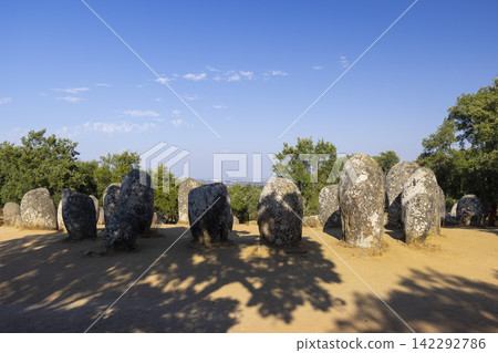 Cromeleque dos Almendres near Evora, Portugal, casting long shadows on a sunny day Cromeleque dos Almendres near Evora, Portugal, casting long shadows on a sunny day 142292786