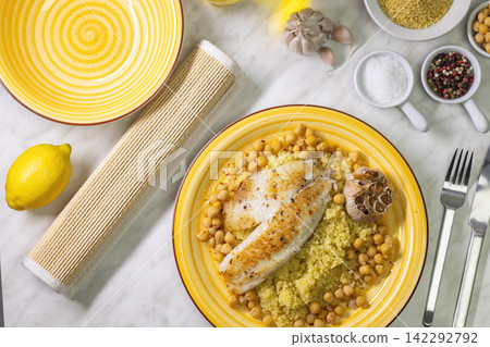 grilled cod with couscous, chicken pea and baked garlic grilled cod with couscous, chicken pea and baked garlic 142292792