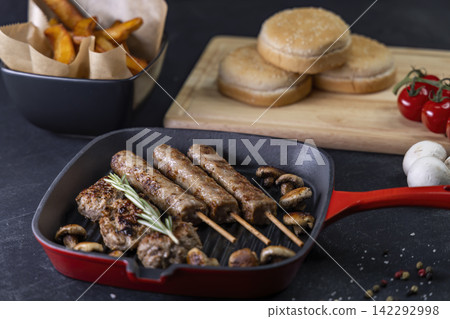 grilled meat and shasliks with mushrooms and tomatos served with french fries grilled meat and shasliks with mushrooms and tomatos served with french fries 142292998