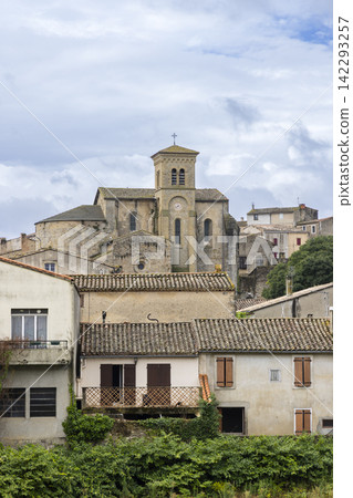 Saint Hilaire Abbey church rising over stone wall in Aude, France Saint Hilaire Abbey church rising over stone wall in Aude, France 142293257
