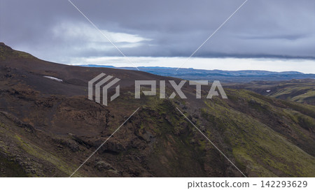 Volcanic terrain with moss-covered lava fields and distant mountains, Skaft?rhreppur Iceland Volcanic terrain with moss-covered lava fields and distant mountains, Skaft?rhreppur Iceland 142293629