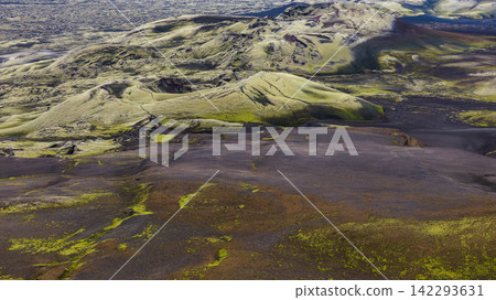 Aerial view of volcanic landscape with moss-covered lava fields and rhyolite mountains, Skaft?rhreppur Iceland Aerial view of volcanic landscape with moss-covered lava fields and rhyolite mountains, Skaft?rhreppur Iceland 142293631