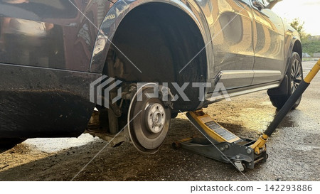 Close-up of a passenger car with the wheel removed during tire replacement. 142293886