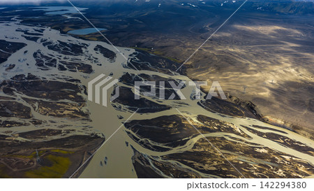 Aerial view of braided glacial river delta with sediment plumes, ytra Iceland Aerial view of braided glacial river delta with sediment plumes, ytra Iceland 142294380