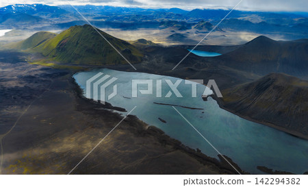 Aerial view of crater lake with turquoise water and moss-covered volcanic cone, ytra Iceland Aerial view of crater lake with turquoise water and moss-covered volcanic cone, ytra Iceland 142294382