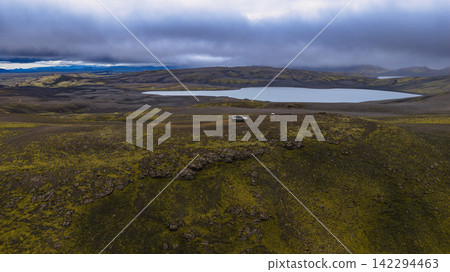 Aerial view of moss-covered lava field with glacial lake Aerial view of moss-covered lava field with glacial lake 142294463