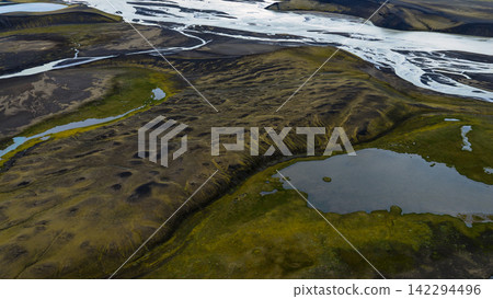 Aerial view of glacial river valley with tundra vegetation and meltwater lakes, ytra Iceland Aerial view of glacial river valley with tundra vegetation and meltwater lakes, ytra Iceland 142294496