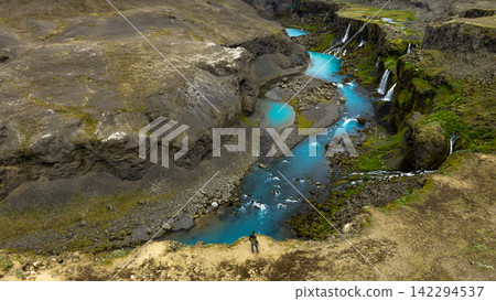 Aerial view of glacial river canyon with turquoise water and waterfalls, ytra Iceland 142294537