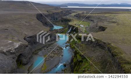 Aerial view of glacial river canyon with turquoise water and columnar basalt,  ytra Iceland 142294550
