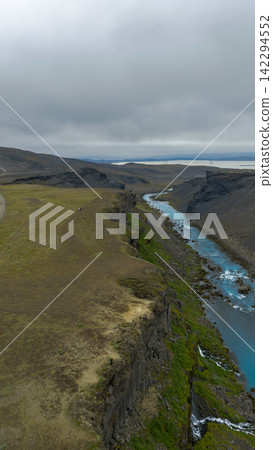 Aerial view of glacial river canyon with turquoise water, Rang?r?ing ytra Iceland Aerial view of glacial river canyon with turquoise water, Rang?r?ing ytra Iceland 142294552