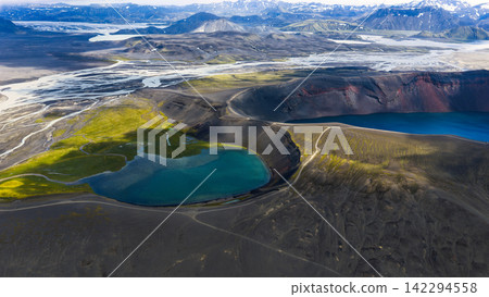 Aerial view of crater lake with turquoise water and moss-covered volcanic terrain, ytra Iceland Aerial view of crater lake with turquoise water and moss-covered volcanic terrain, ytra Iceland 142294558