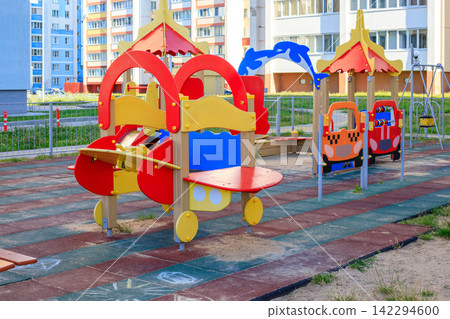 Bright kids play complex with slides and car shapes. Urban infrastructure and child recreation. Bright kids play complex with slides and car shapes. Urban infrastructure and child recreation. 142294600