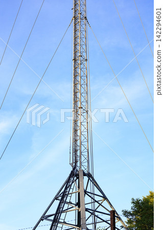 Telecommunications tower with mobile antennas at a clear sky. Signal transmission, modern technology, network connectivity. Vertical image Telecommunications tower with mobile antennas at a clear sky. Signal transmission, modern technology, network connectivity. Vertical image 142294601