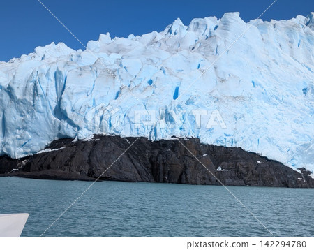 Jagged Blue Glacier Front With Dark Rock Outcrop in Patagonia Jagged Blue Glacier Front With Dark Rock Outcrop in Patagonia 142294780