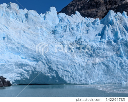 Textured Blue Ice Wall of Spegazzini Glacier Above Glacial Lake Textured Blue Ice Wall of Spegazzini Glacier Above Glacial Lake 142294785