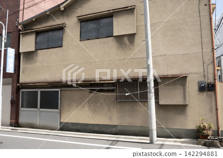 The facade of this old building has a nostalgic charm, with rainwater stains on the walls that have developed over time. The facade of this old building has a nostalgic charm, with rainwater stains on the walls that have developed over time. 142294881