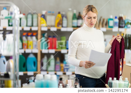 Pregnant saleswoman in store aisle worried over maternity leave terms Pregnant saleswoman in store aisle worried over maternity leave terms 142295174