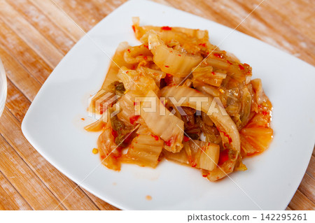 Korean kimchi of marinated napa cabbage with spicy pepper Korean kimchi of marinated napa cabbage with spicy pepper 142295261
