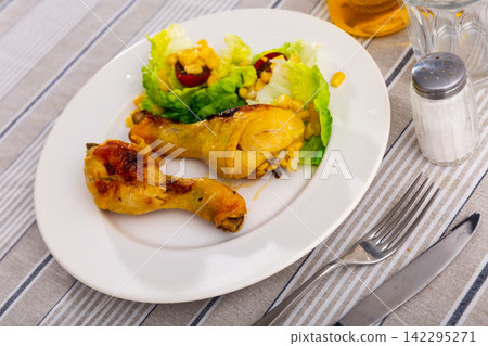 Baked chicken pieces with salad of lettuce and corn Baked chicken pieces with salad of lettuce and corn 142295271