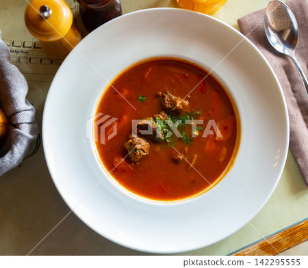 Popular dish of Russian cuisine is an appetizing hearty meat soup goulash Popular dish of Russian cuisine is an appetizing hearty meat soup goulash 142295555