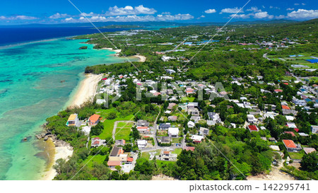 Aerial view of the sea and village scenery in Nakijin Village, northern Okinawa Island. Aerial view of the sea and village scenery in Nakijin Village, northern Okinawa Island. 142295741