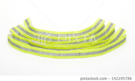 Stack of neon yellow reflective slap bands curved against a clean white background with reflective visibility accessory equipment security protection fluorescent material flexible bendable Stack of neon yellow reflective slap bands curved against a clean white background with reflective visibility accessory equipment security protection fluorescent material flexible bendable 142295786