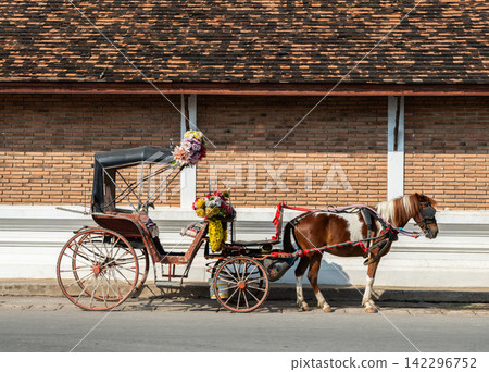 The horse carriage (horse-drawn carriage) in Lampang province of Thailand. Lampang is the only town in Thailand that still has horse carriages for transportation service. The horse carriage (horse-drawn carriage) in Lampang province of Thailand. Lampang is the only town in Thailand that still has horse carriages for transportation service. 142296752