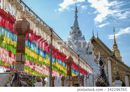 Traditional paper lanterns hanging on the rows in Wat Phra That Hariphunchai, Lamphun province of Thailand during Yi peng (or Yee peng) festival. Traditional paper lanterns hanging on the rows in Wat Phra That Hariphunchai, Lamphun province of Thailand during Yi peng (or Yee peng) festival. 142296765