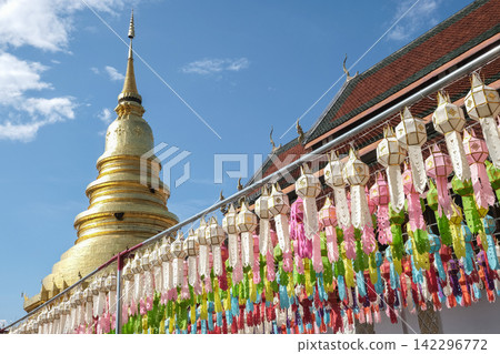 Traditional paper lanterns hanging on the rows in Wat Phra That Hariphunchai, Lamphun province of Thailand during Yi peng (or Yee peng) festival. Traditional paper lanterns hanging on the rows in Wat Phra That Hariphunchai, Lamphun province of Thailand during Yi peng (or Yee peng) festival. 142296772
