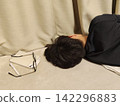 A man who is tired from studying and falls asleep. 142296883