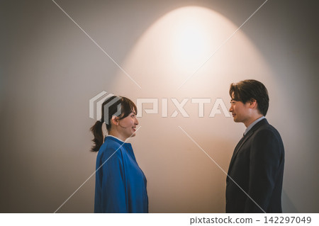 An office romance scene between a man and a woman that suggests a fateful encounter. An office romance scene between a man and a woman that suggests a fateful encounter. 142297049