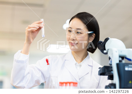 Research Image: A woman working in a research lab. Photography cooperation: Denpa Gakuen Tokyo Electronics College. Research Image: A woman working in a research lab. Photography cooperation: Denpa Gakuen Tokyo Electronics College. 142297226