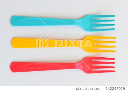 colorful fork isolated on white background, plastic cutlery for picnic colorful fork isolated on white background, plastic cutlery for picnic 142297929