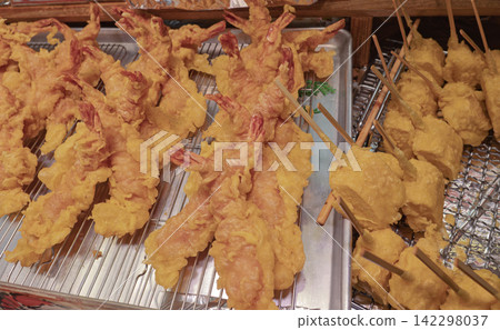 A display of freshly fried large shrimp tempura and fragrant skewered tempura. A display of freshly fried large shrimp tempura and fragrant skewered tempura. 142298037