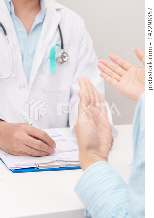 Doctor and patient having a medical consultation for Teal and white ribbon concept of January Cervical Cancer Awareness month, September Ovarian Cancer, PCOS, April Sexual Assault Doctor and patient having a medical consultation for Teal and white ribbon concept of January Cervical Cancer Awareness month, September Ovarian Cancer, PCOS, April Sexual Assault 142298352