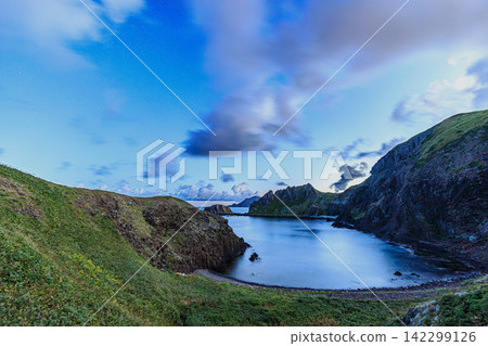 The beautiful dawn at Sumikai Cape on Rebun Island in Rishiri-Rebun-Sarobetsu National Park, with its blue gradient sky and sea. The beautiful dawn at Sumikai Cape on Rebun Island in Rishiri-Rebun-Sarobetsu National Park, with its blue gradient sky and sea. 142299126