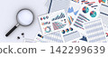 Printed business data documents and a magnifying glass, for verifying business materials. 142299639