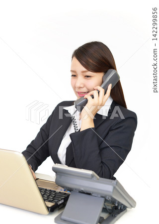 Female employee answering the phone Female employee answering the phone 142299856