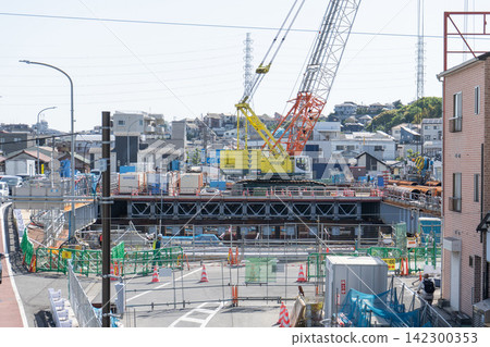 Crawler crane and steel pipe sheet piles at the Sueyoshi Bridge replacement construction site. Crawler crane and steel pipe sheet piles at the Sueyoshi Bridge replacement construction site. 142300353